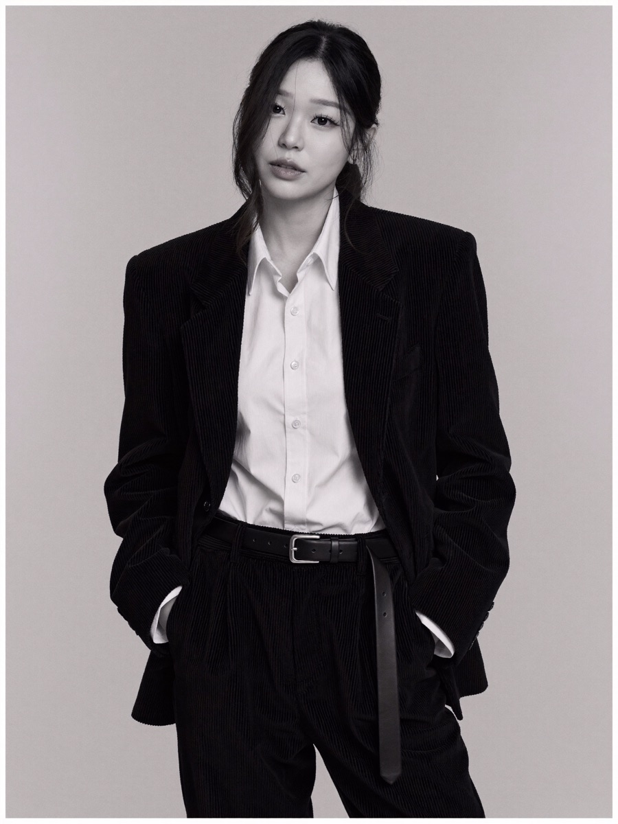 Oversized black corduroy suit, head tilted back, black and white editorial