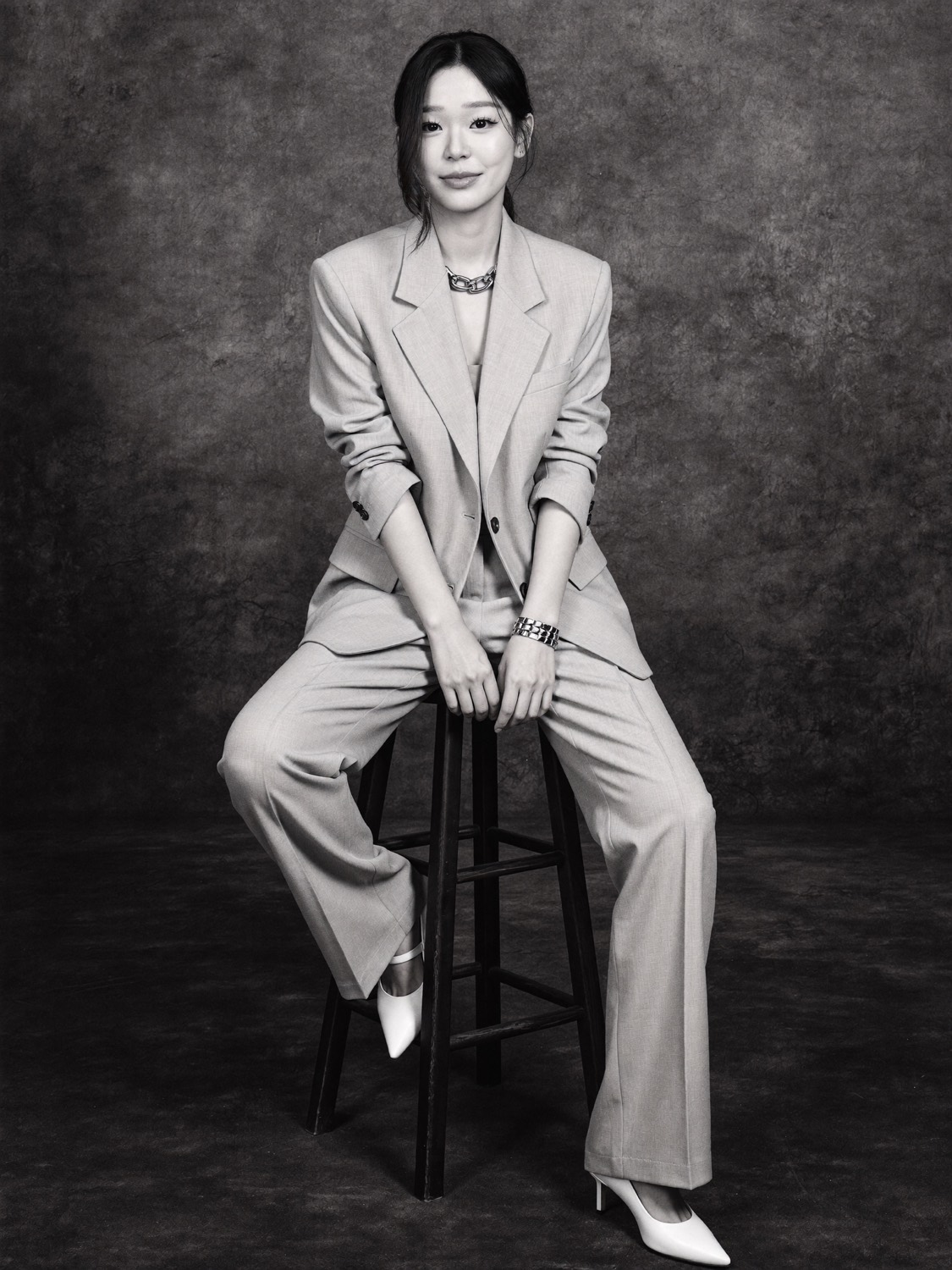 Cindy's generated portrait: Oversized suit on the stool (black and white)