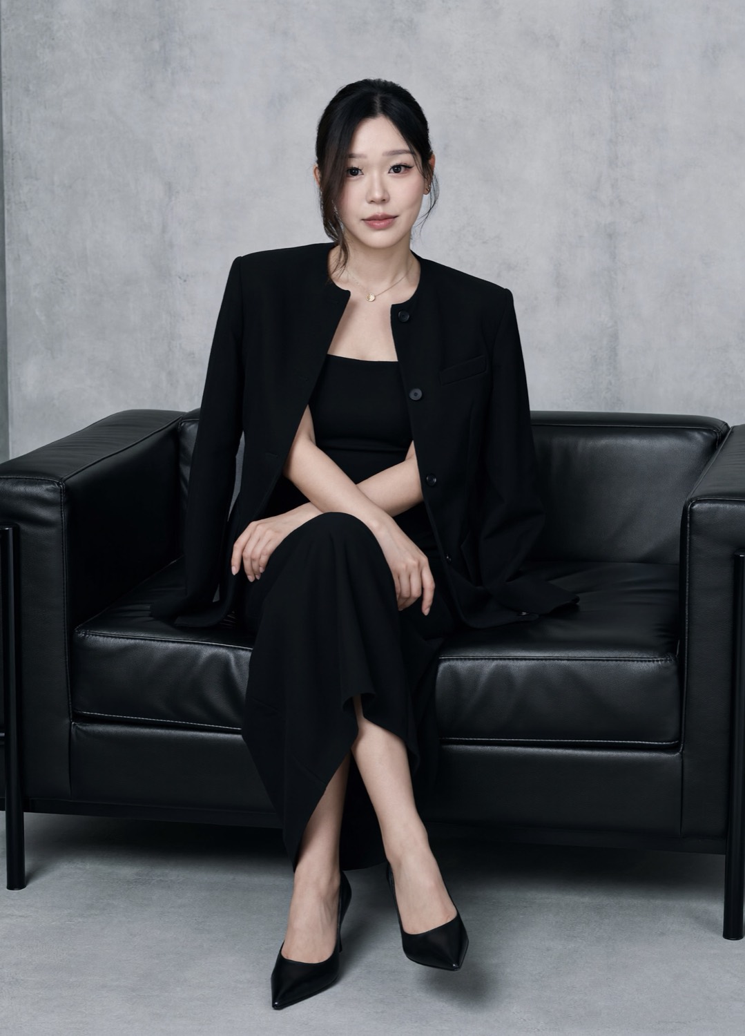 Cindy's generated portrait: All black on the leather sofa