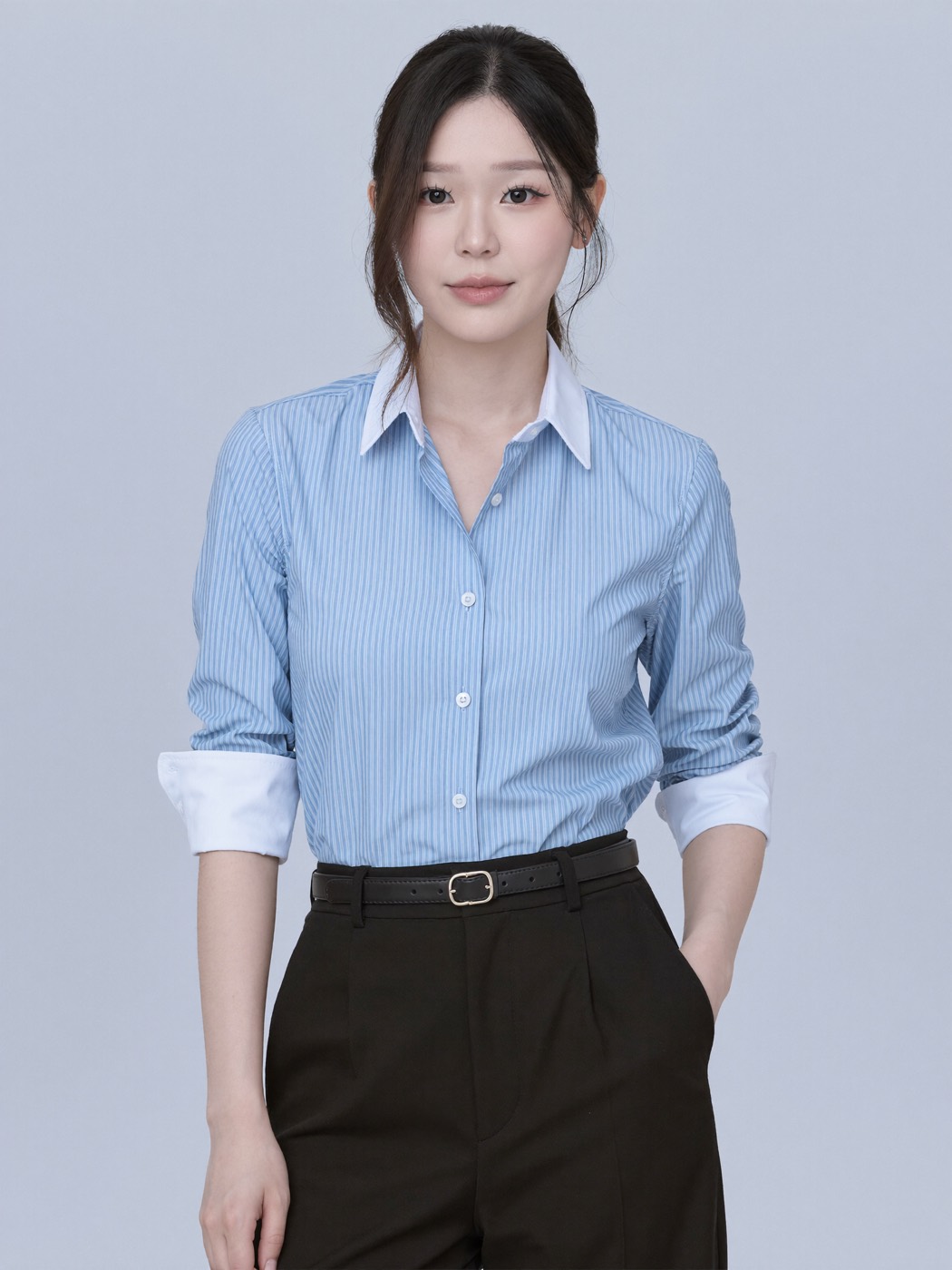 Blue pinstripe shirt with rolled sleeves and black trousers on pale blue
