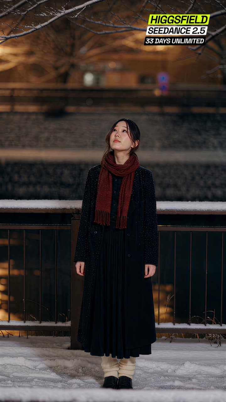 Reference frame: full-body shot of her standing in the snow by a canal railing, looking up at bare branches